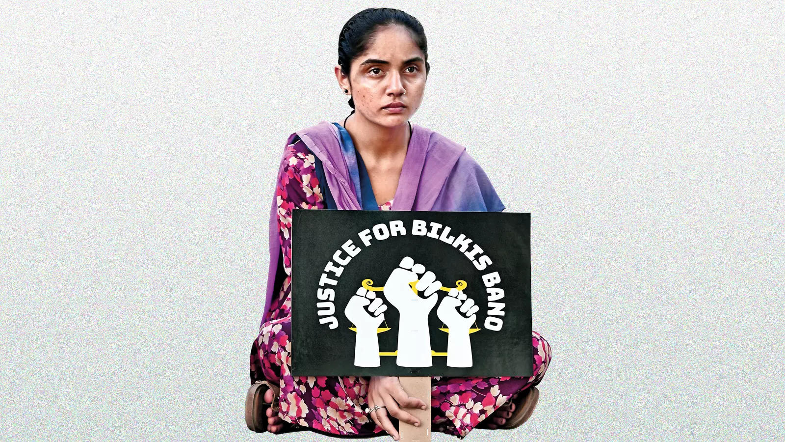 A seated lady holding a poster saying Justice for Bilkis Bano with an image of three raised fists