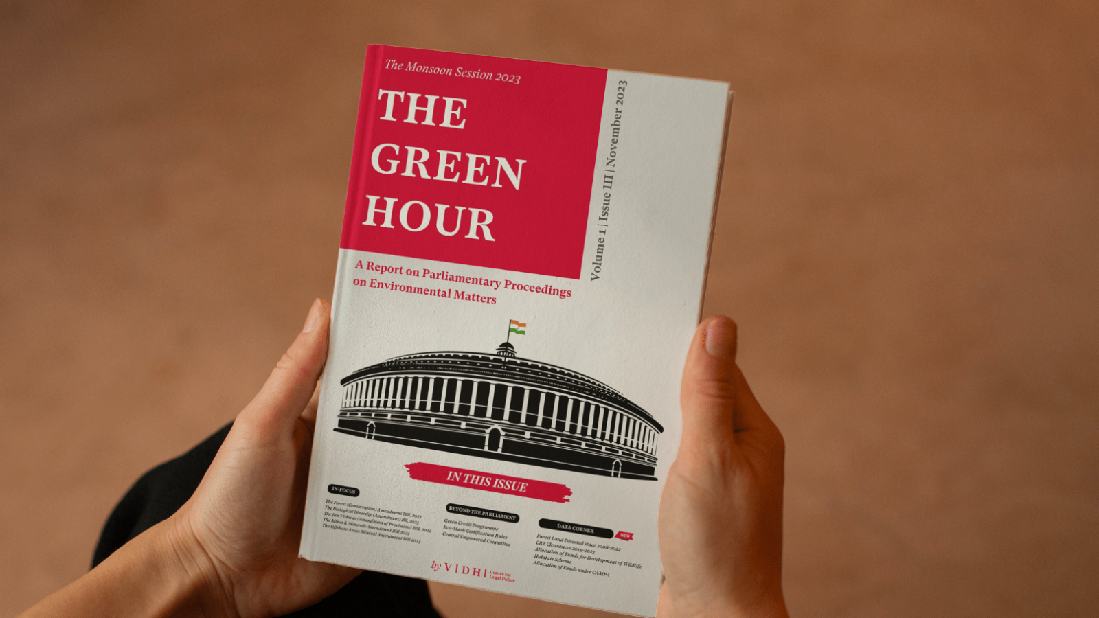A person holding a harcopy of the green hour publication